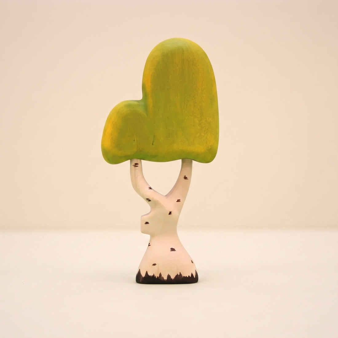 Wooden birch tree with a pale white trunk and a soft yellow green canopy