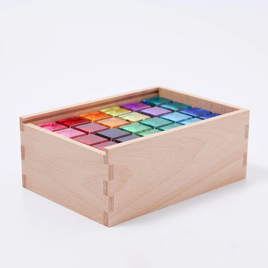 Side view of the Bauspiel Luminous Blocks wooden box filled with 12 colors