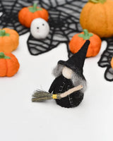 Felt peg doll witch in a long cloak on a silver birch body, holding a broom · view 1