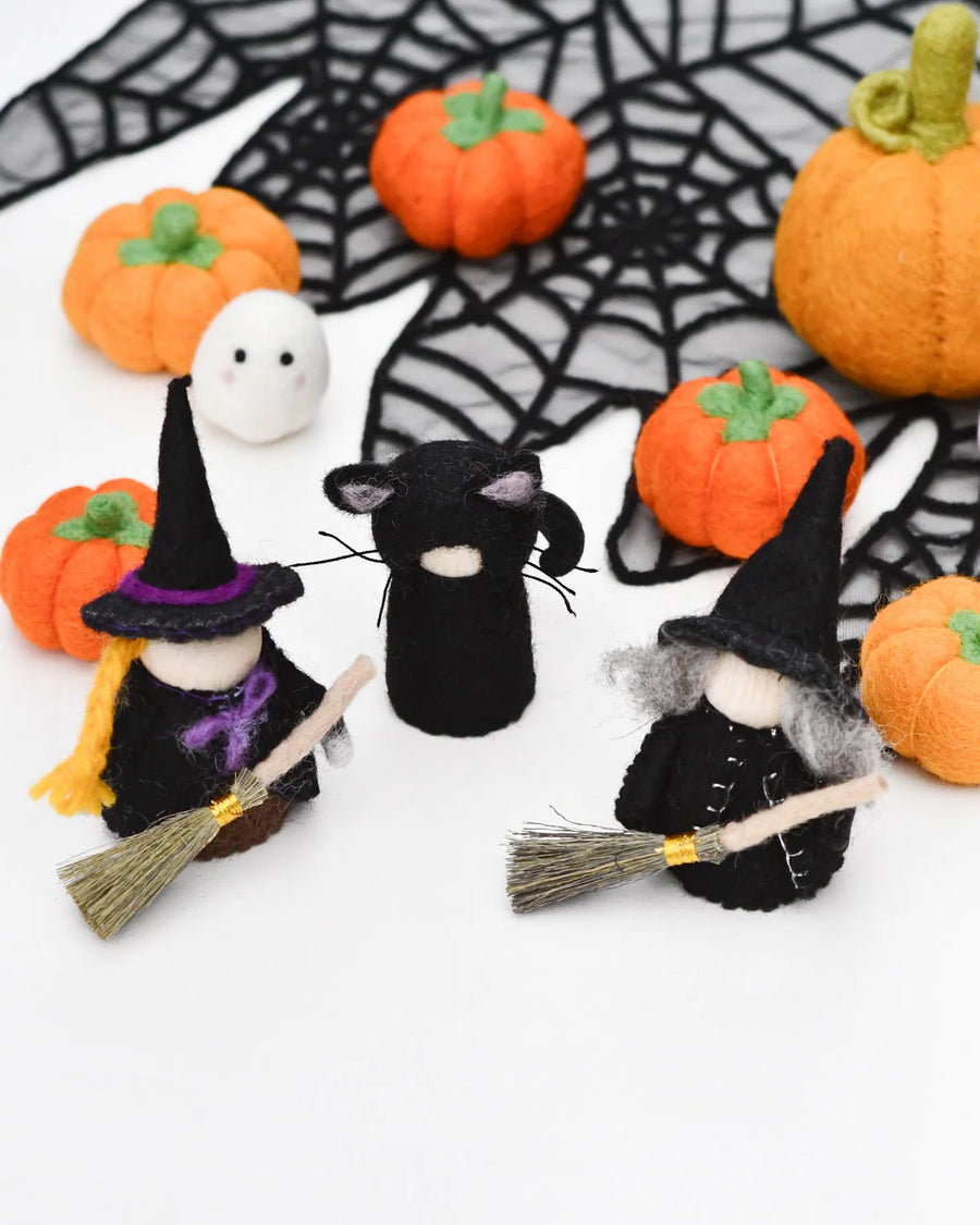 Cloaked felt witch peg doll shown from behind