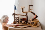Q Toys Tree House Complex, natural branch play village on a shaped base with swing, stairs and flag · view 1