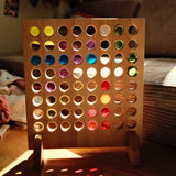 Bauspiel Four in a Row Game Board in sunlight with lucent cylinders casting colored light on the floor · view 3