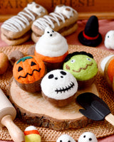 Second view of the four felt Halloween cupcakes showing the needle-felted toppers · view 2