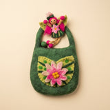 The felt fairy out of the bag, with pink hair, green leaf wings and a green dress with a pink flower · view 2